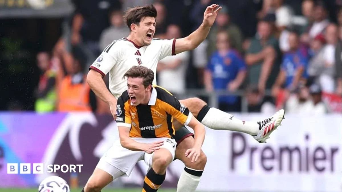 Two players competing during a football match Two players competing during a football match