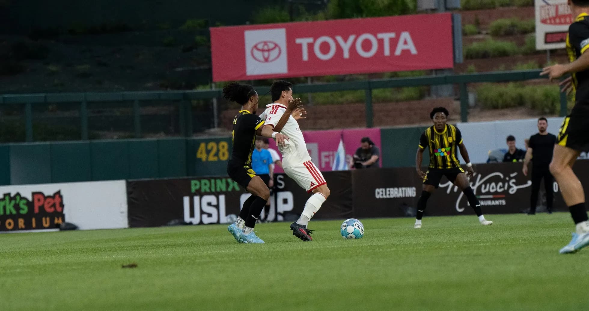 Players battling for the ball in USL Cup match Players battling for the ball in USL Cup match