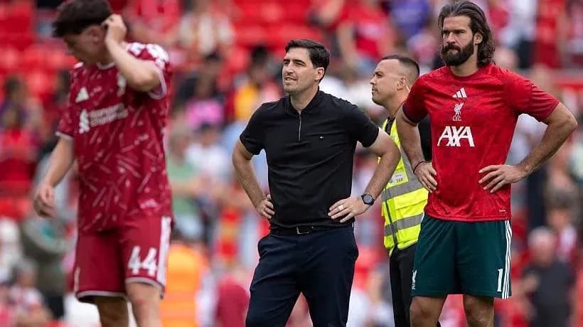 Liverpool players and coach on the pitch during match Liverpool players and coach on the pitch during match
