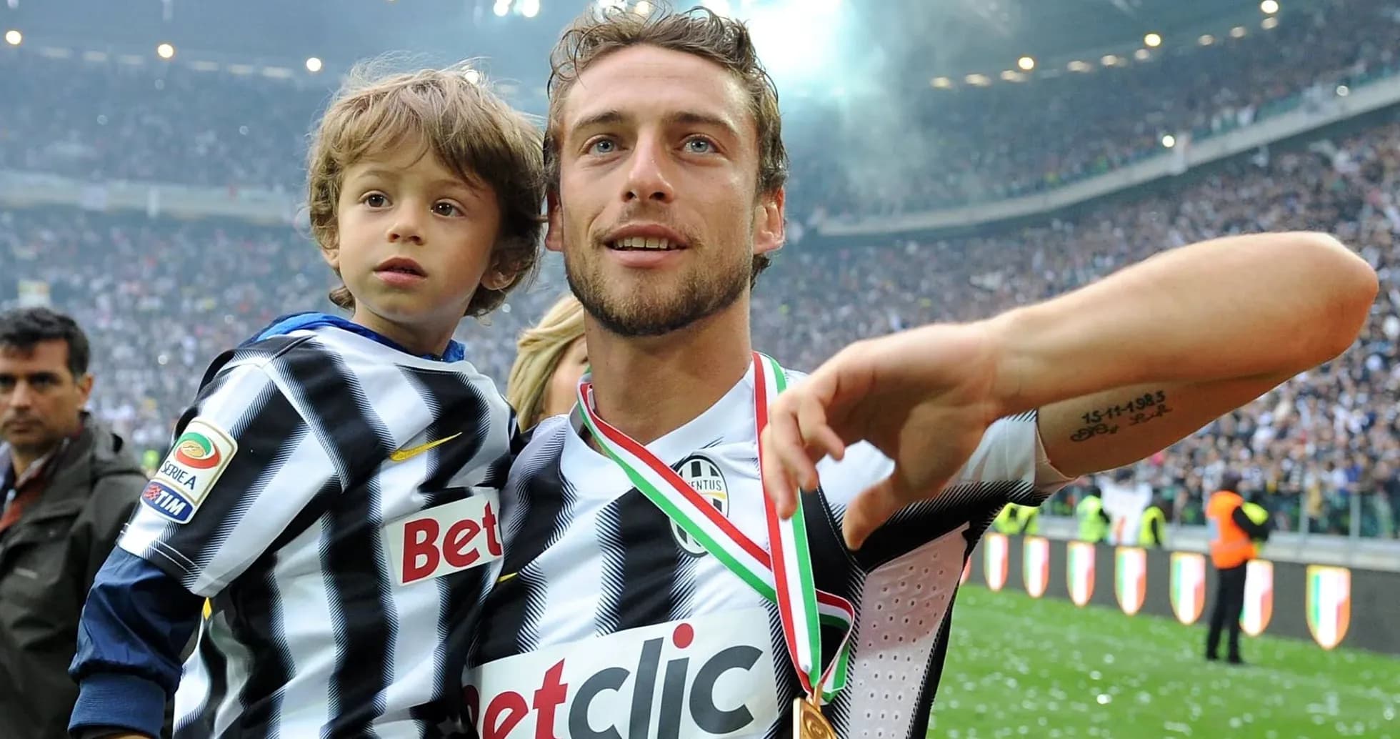 Player celebrating with child on the field Player celebrating with child on the field