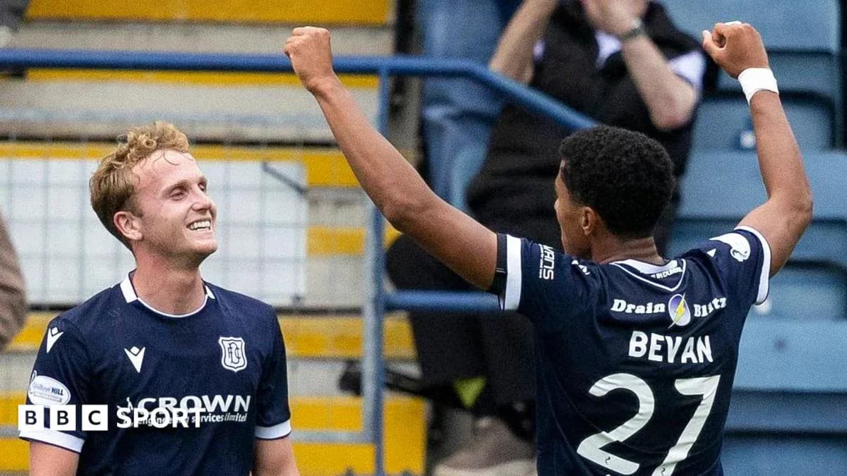 Two players celebrating a goal on the pitch Two players celebrating a goal on the pitch