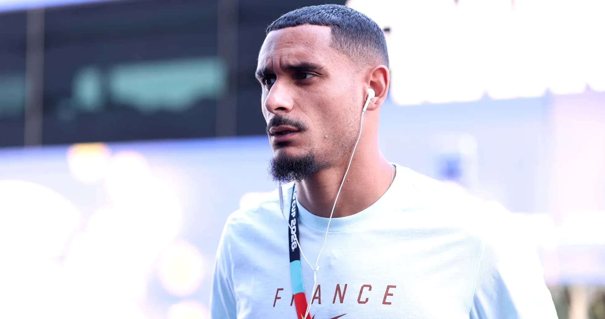 Player wearing headphones walking towards venue Player wearing headphones walking towards venue