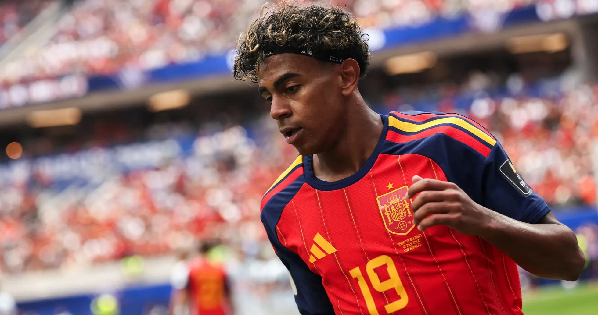 Player in Spain jersey running on field Player in Spain jersey running on field