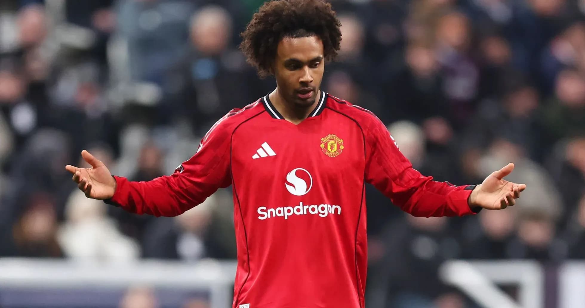 Player in red Manchester United kit on pitch Player in red Manchester United kit on pitch
