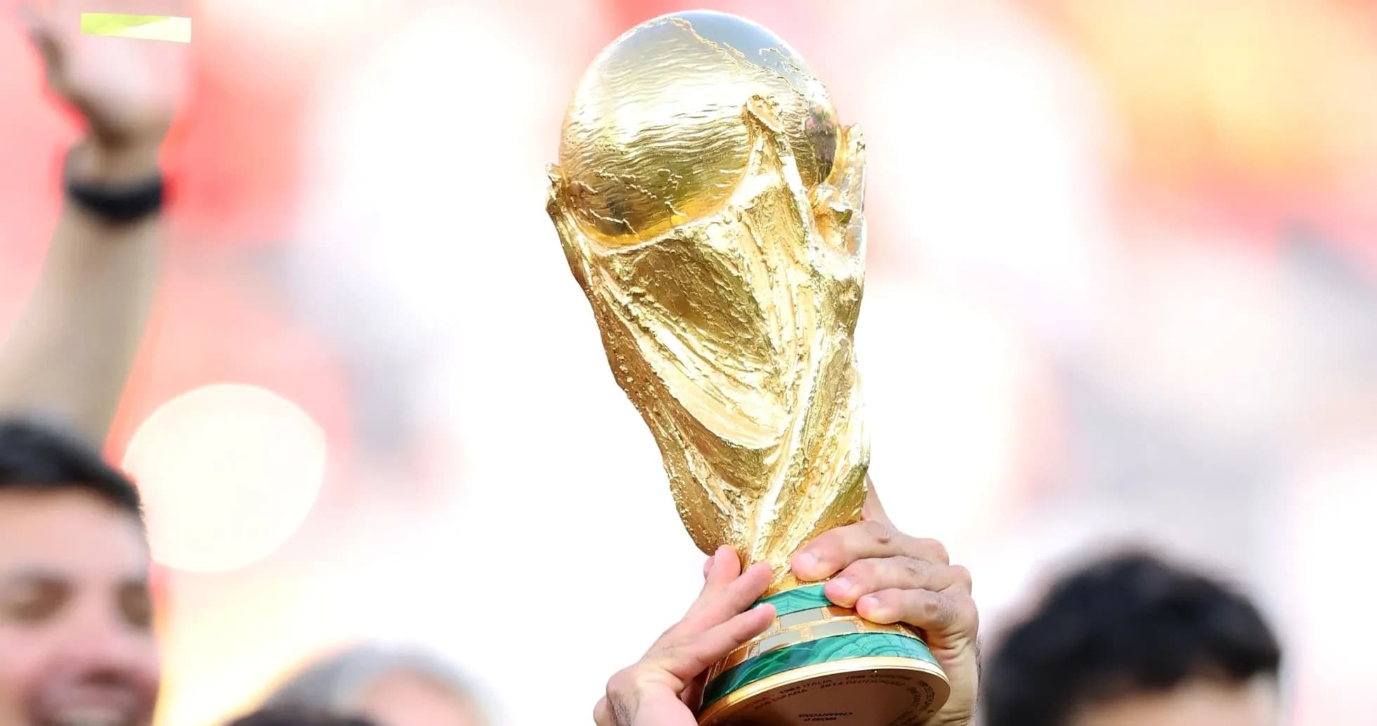 Golden FIFA World Cup trophy being held aloft Golden FIFA World Cup trophy being held aloft