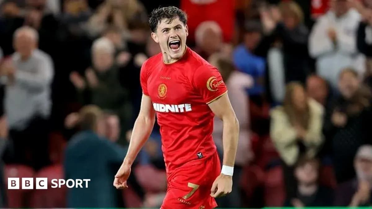 Player celebrating a goal in red jersey Player celebrating a goal in red jersey