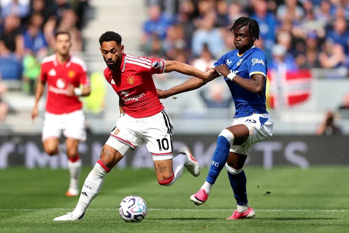 Player in red dribbling past defender in blue Player in red dribbling past defender in blue