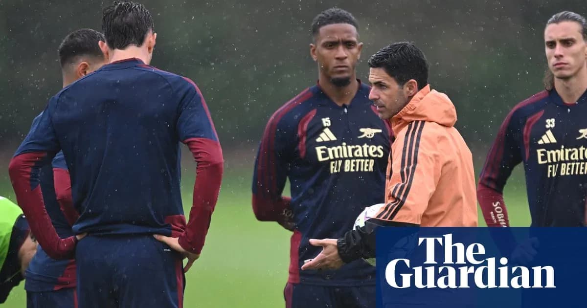 Manager speaking to players during rainy training session Manager speaking to players during rainy training session