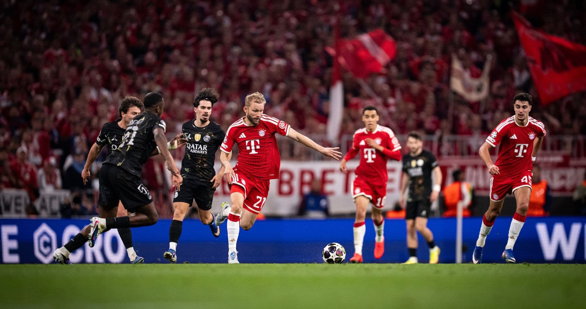Bayern player dribbling past PSG defenders Bayern player dribbling past PSG defenders