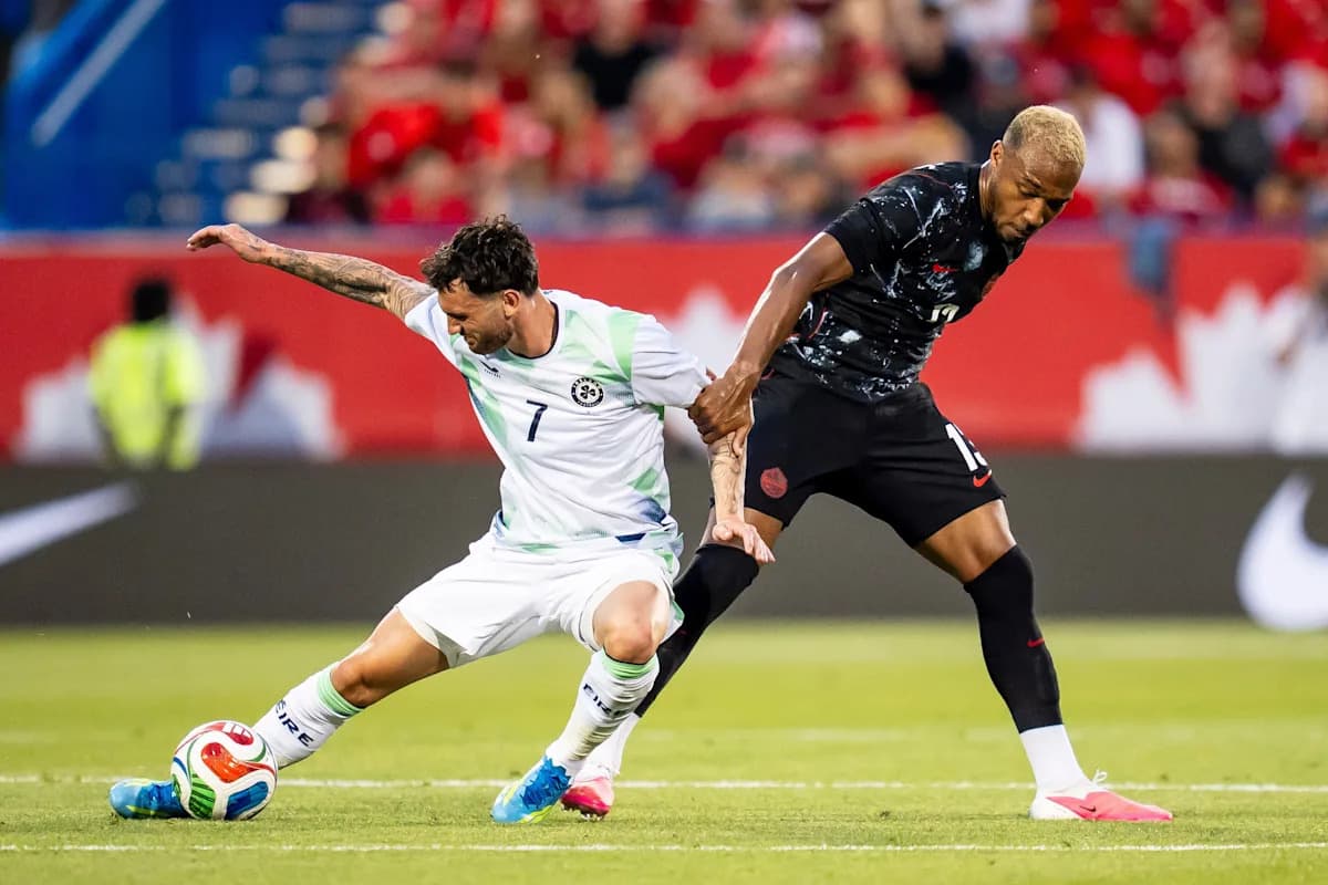 Two soccer players competing for the ball Two soccer players competing for the ball
