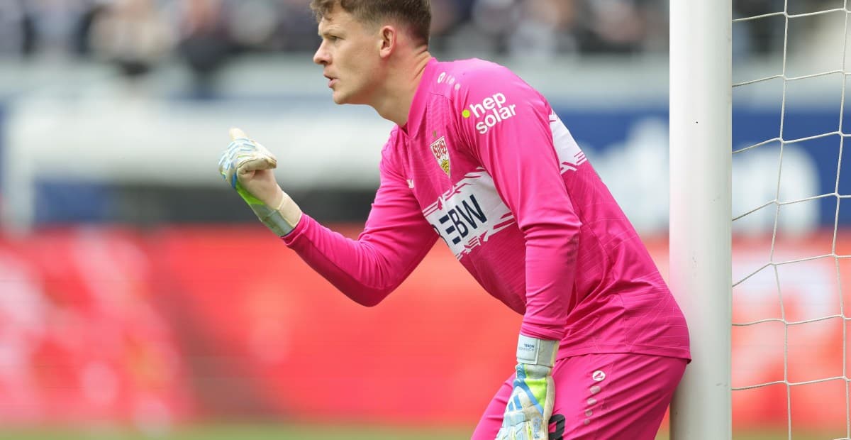 Goalkeeper in pink uniform signaling during match Goalkeeper in pink uniform signaling during match