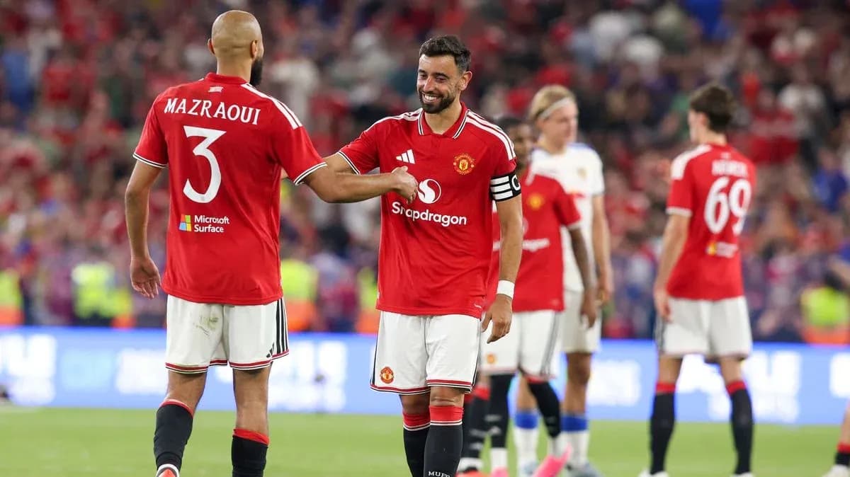 Two Manchester United players celebrating on the pitch Two Manchester United players celebrating on the pitch