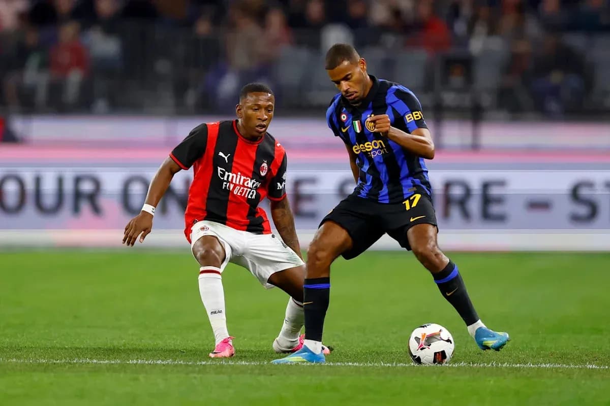 Two players contesting the ball during a match Two players contesting the ball during a match