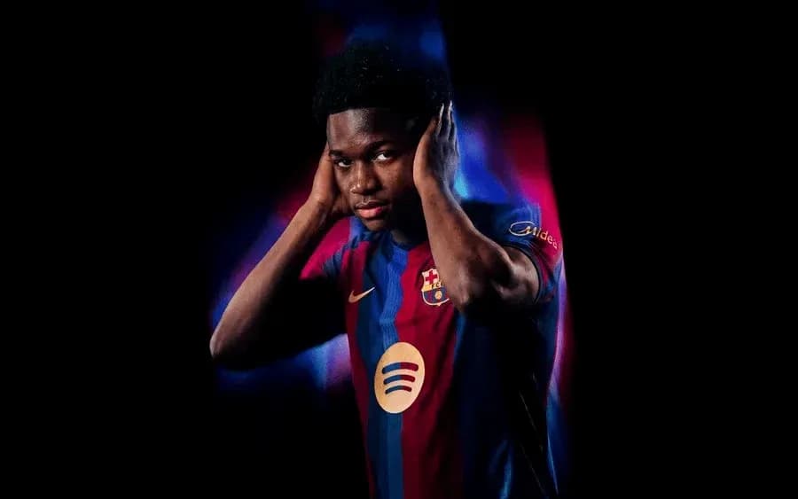 Player wearing Barcelona jersey with hands on ears Player wearing Barcelona jersey with hands on ears