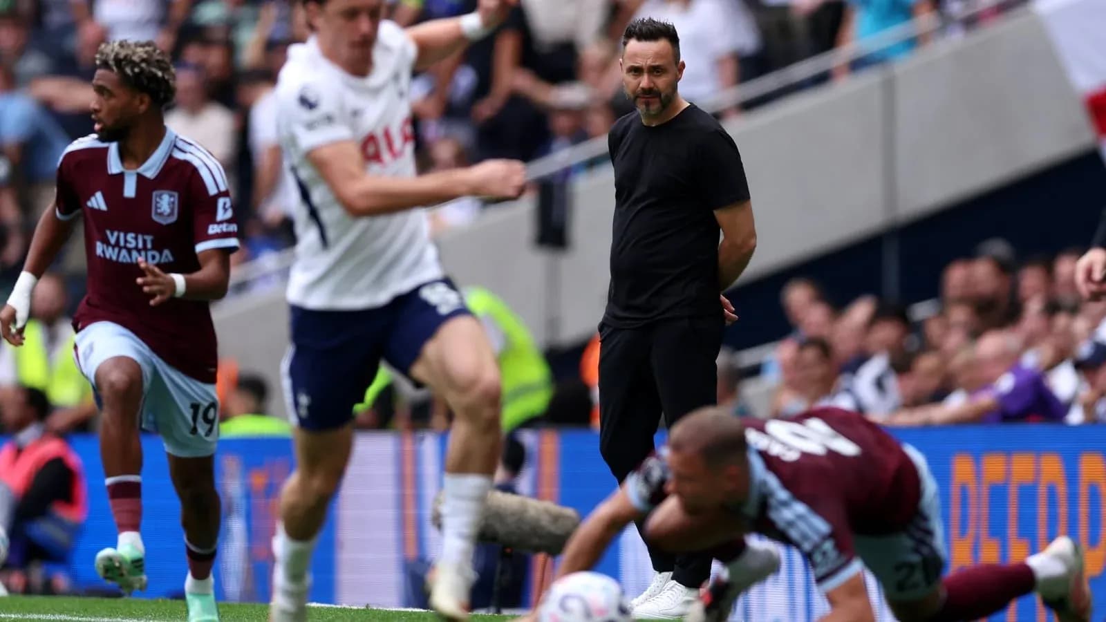 Aston Villa player dribbling past opponent on pitch Aston Villa player dribbling past opponent on pitch