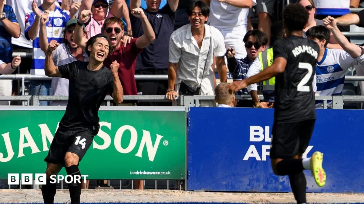 Player celebrating goal with fans in background Player celebrating goal with fans in background