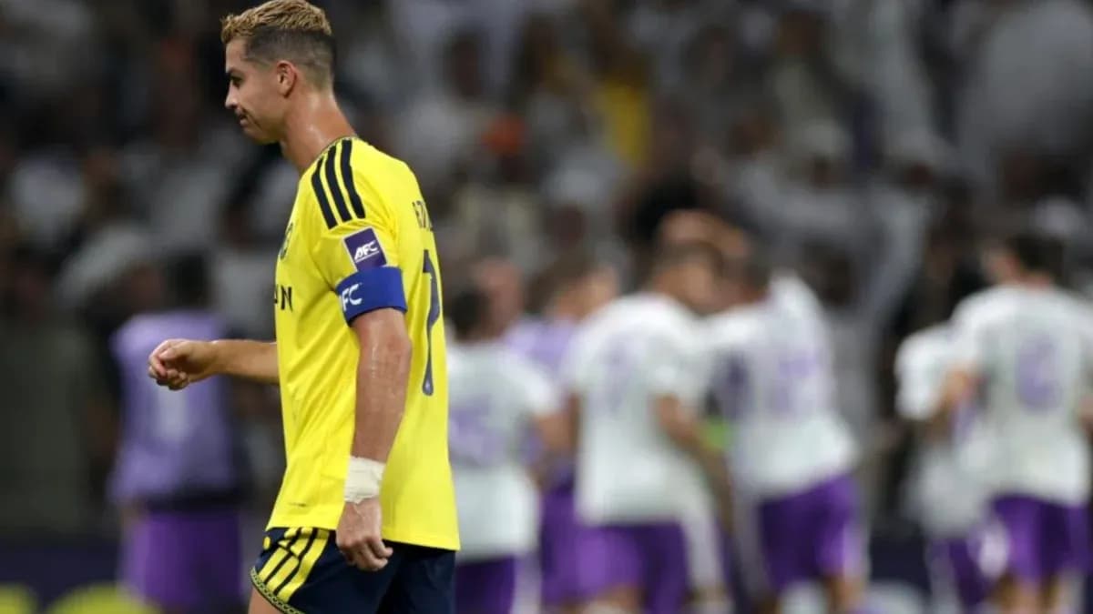 Player in yellow jersey walking past celebrating teammates Player in yellow jersey walking past celebrating teammates