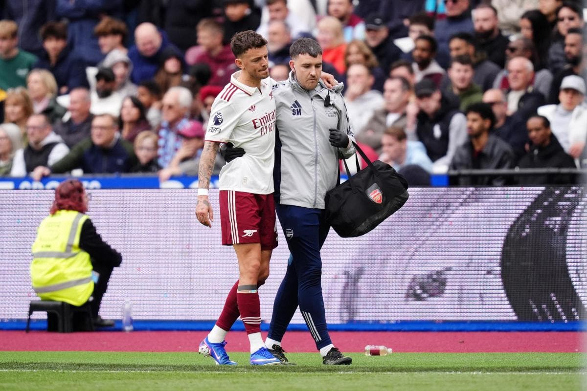 Player receiving assistance from medical staff on pitch Player receiving assistance from medical staff on pitch
