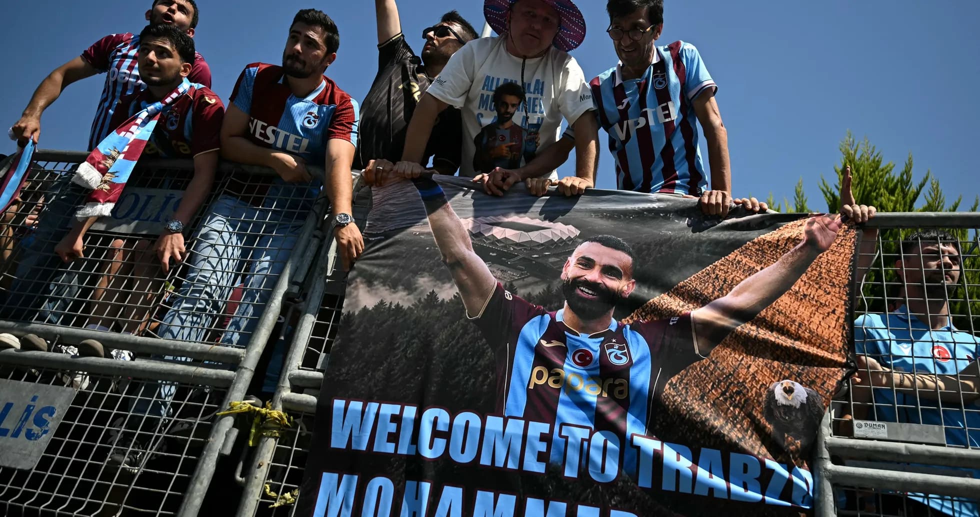 Fans holding a banner welcoming Mohammed Salah Fans holding a banner welcoming Mohammed Salah