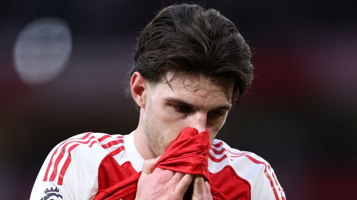 Player holding jersey close to face on pitch Player holding jersey close to face on pitch