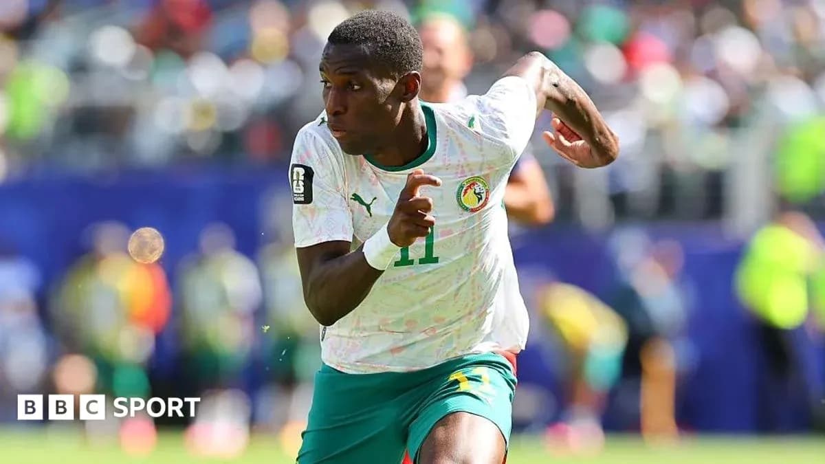 Senegal player sprinting during a football match Senegal player sprinting during a football match