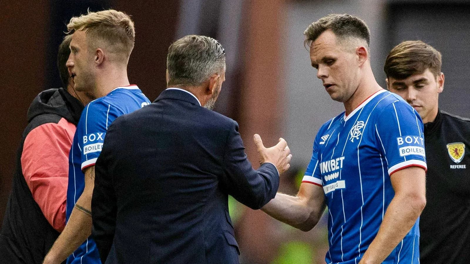 Rangers players interacting with manager on sideline Rangers players interacting with manager on sideline