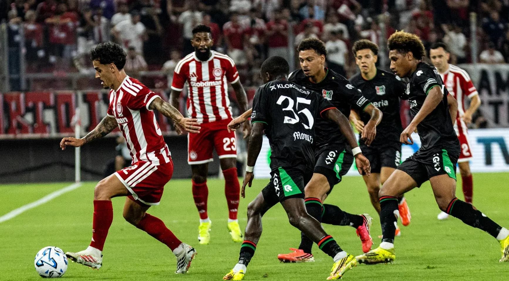 Olympiakos Piraeus player dribbling against NEC Nijmegen Olympiakos Piraeus player dribbling against NEC Nijmegen