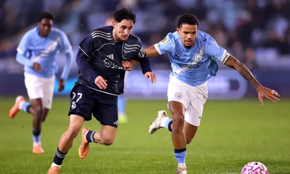 Real Madrid and Manchester City players racing for the ball Real Madrid and Manchester City players racing for the ball