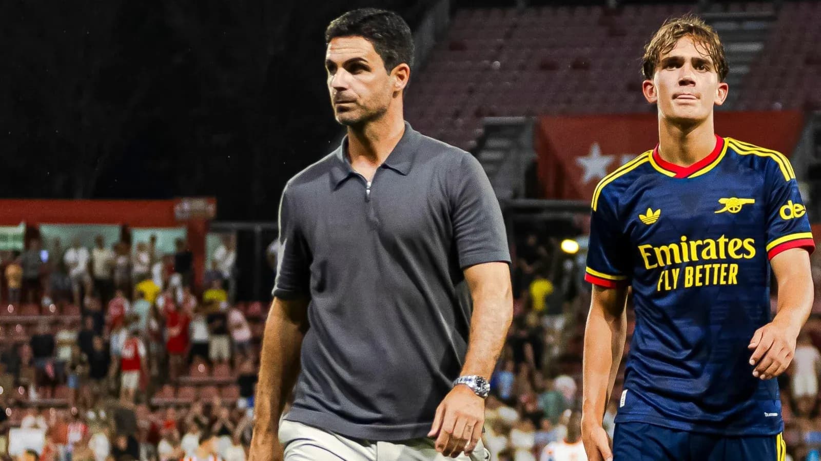 Manager and player walking off the field after match Manager and player walking off the field after match