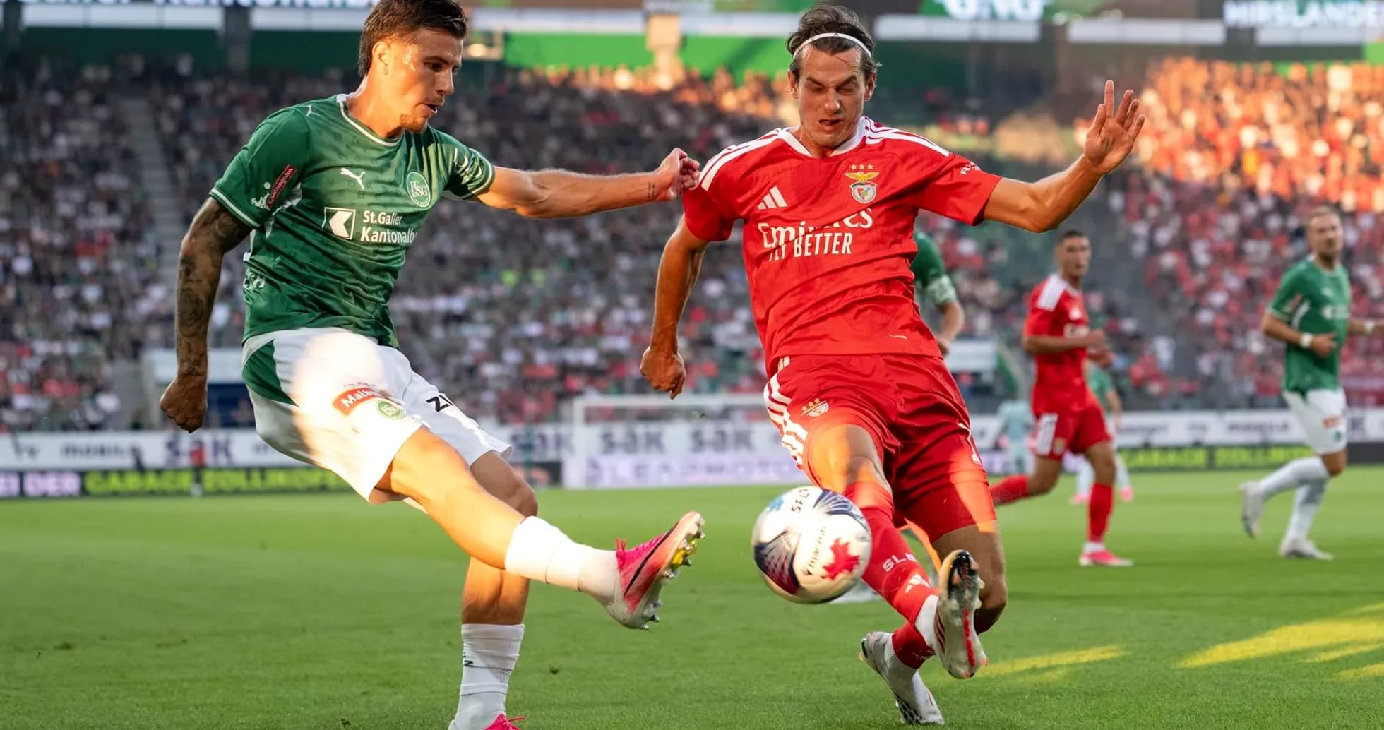 Benfica player challenging FC St. Gallen opponent Benfica player challenging FC St. Gallen opponent