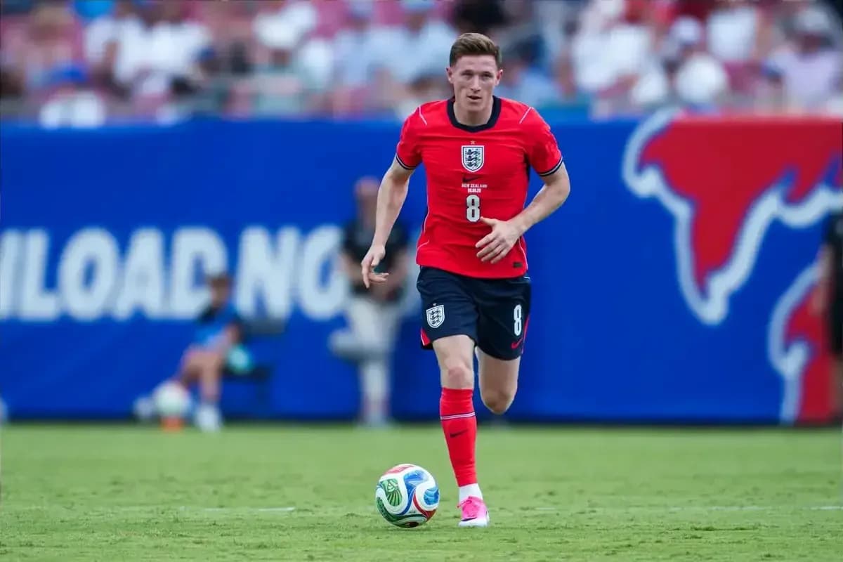 Player in red uniform dribbling soccer ball on field Player in red uniform dribbling soccer ball on field