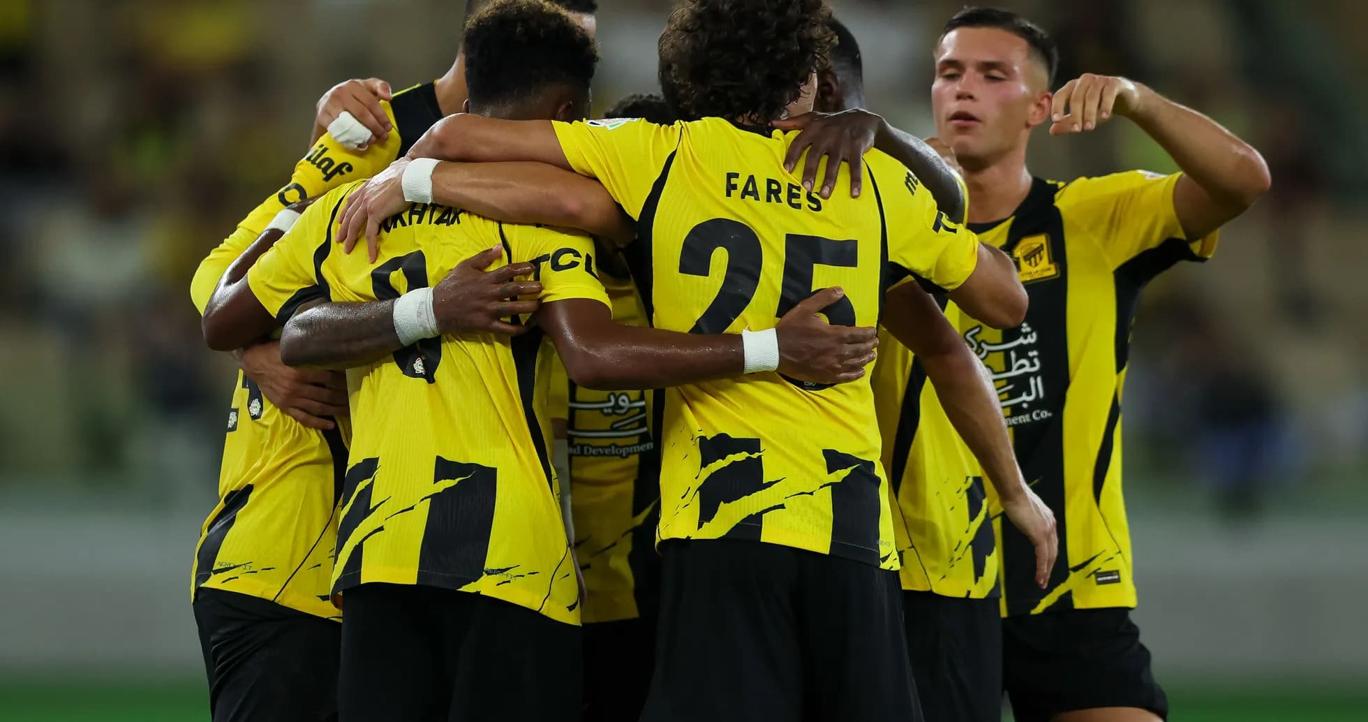 Players celebrating a goal in team huddle Players celebrating a goal in team huddle