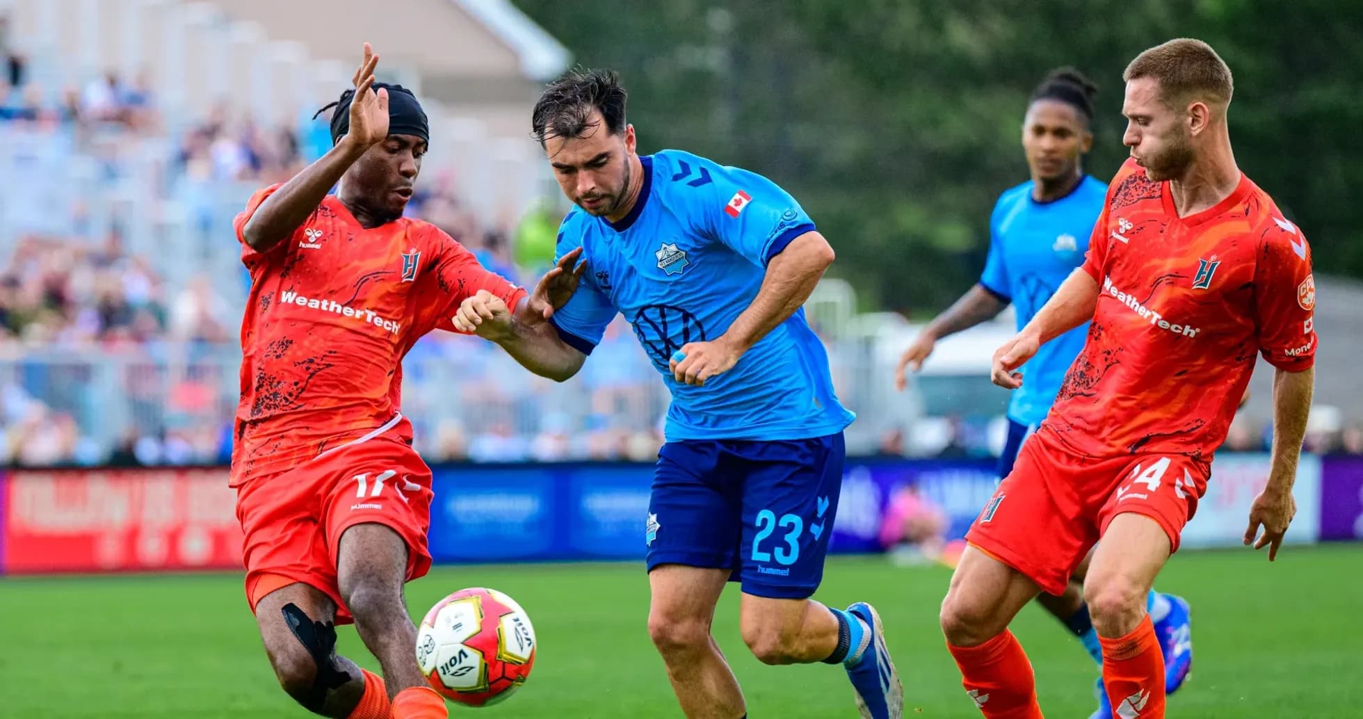 Players contesting for the ball during match Players contesting for the ball during match