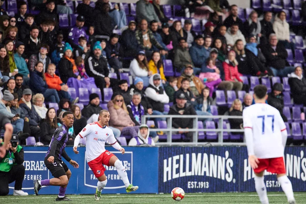Vancouver FC player dribbling the ball during match Vancouver FC player dribbling the ball during match