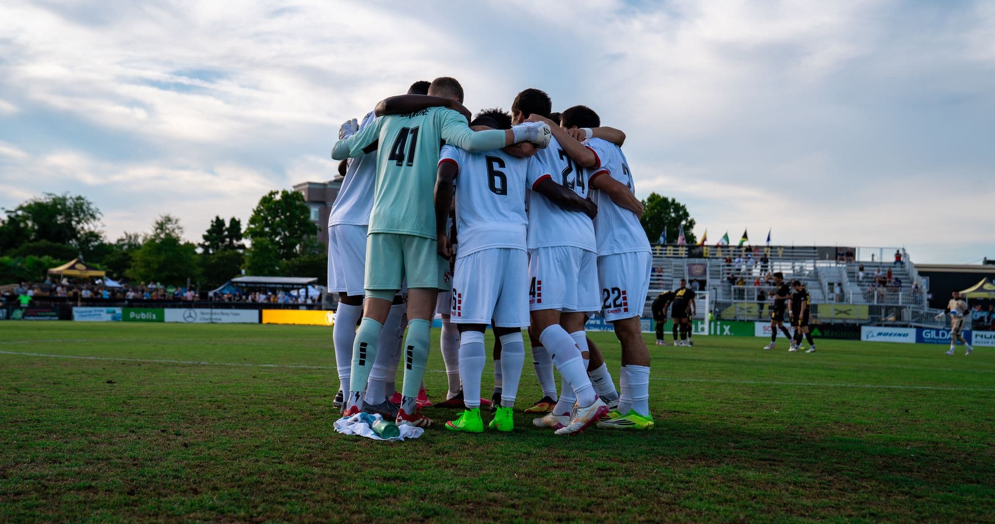 Players huddling before the match Players huddling before the match
