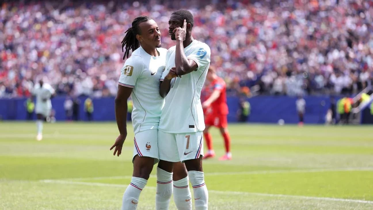Two French players celebrating on the pitch Two French players celebrating on the pitch