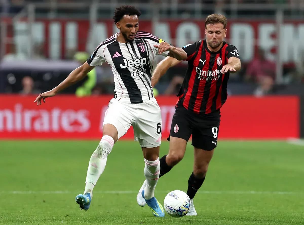 Juventus player tackling AC Milan opponent Juventus player tackling AC Milan opponent