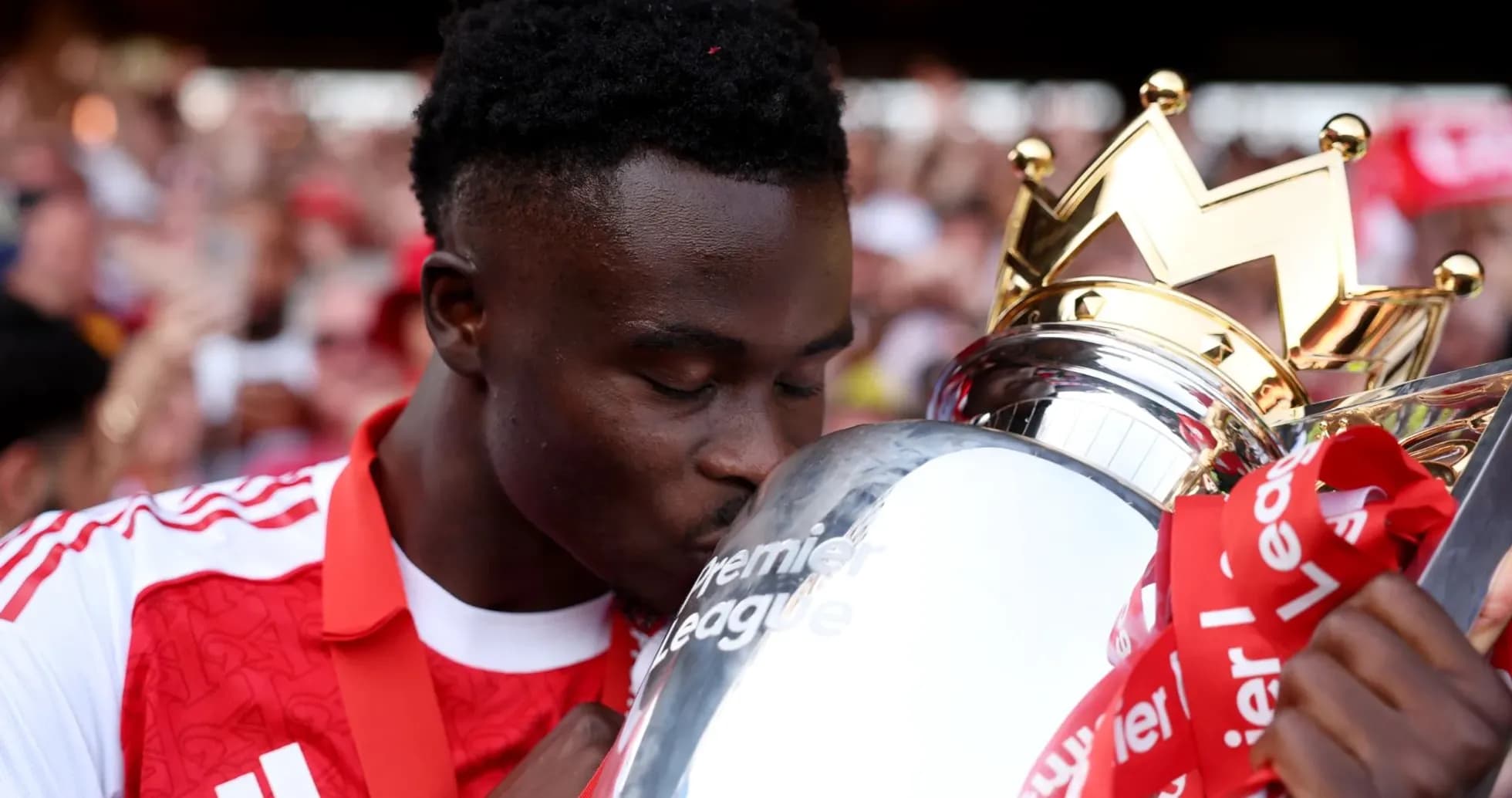 Player kissing Premier League trophy during celebration Player kissing Premier League trophy during celebration