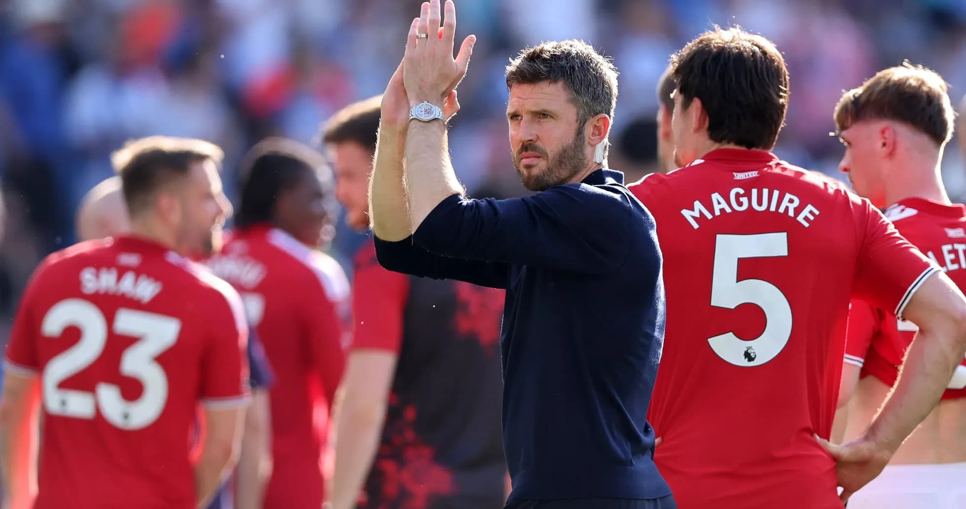 Manager applauding players after match conclusion Manager applauding players after match conclusion