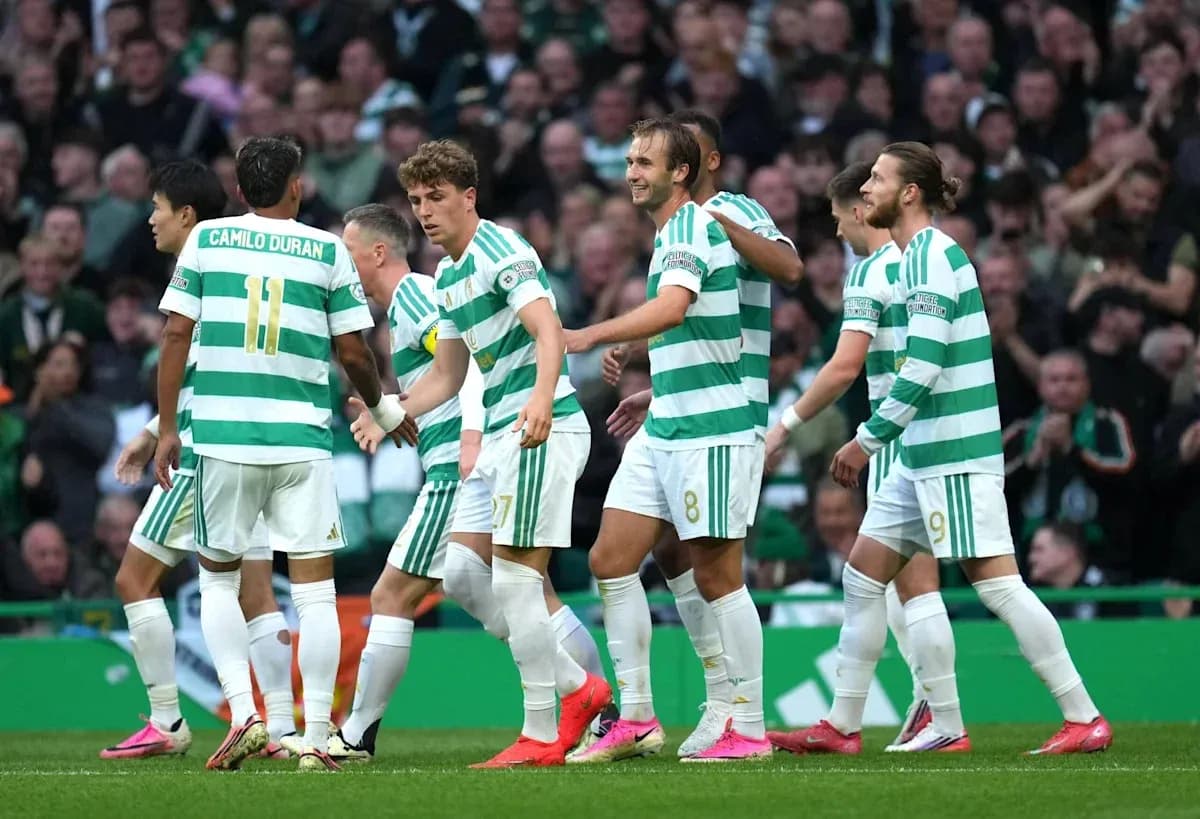 Celtic players celebrating a goal on the pitch Celtic players celebrating a goal on the pitch