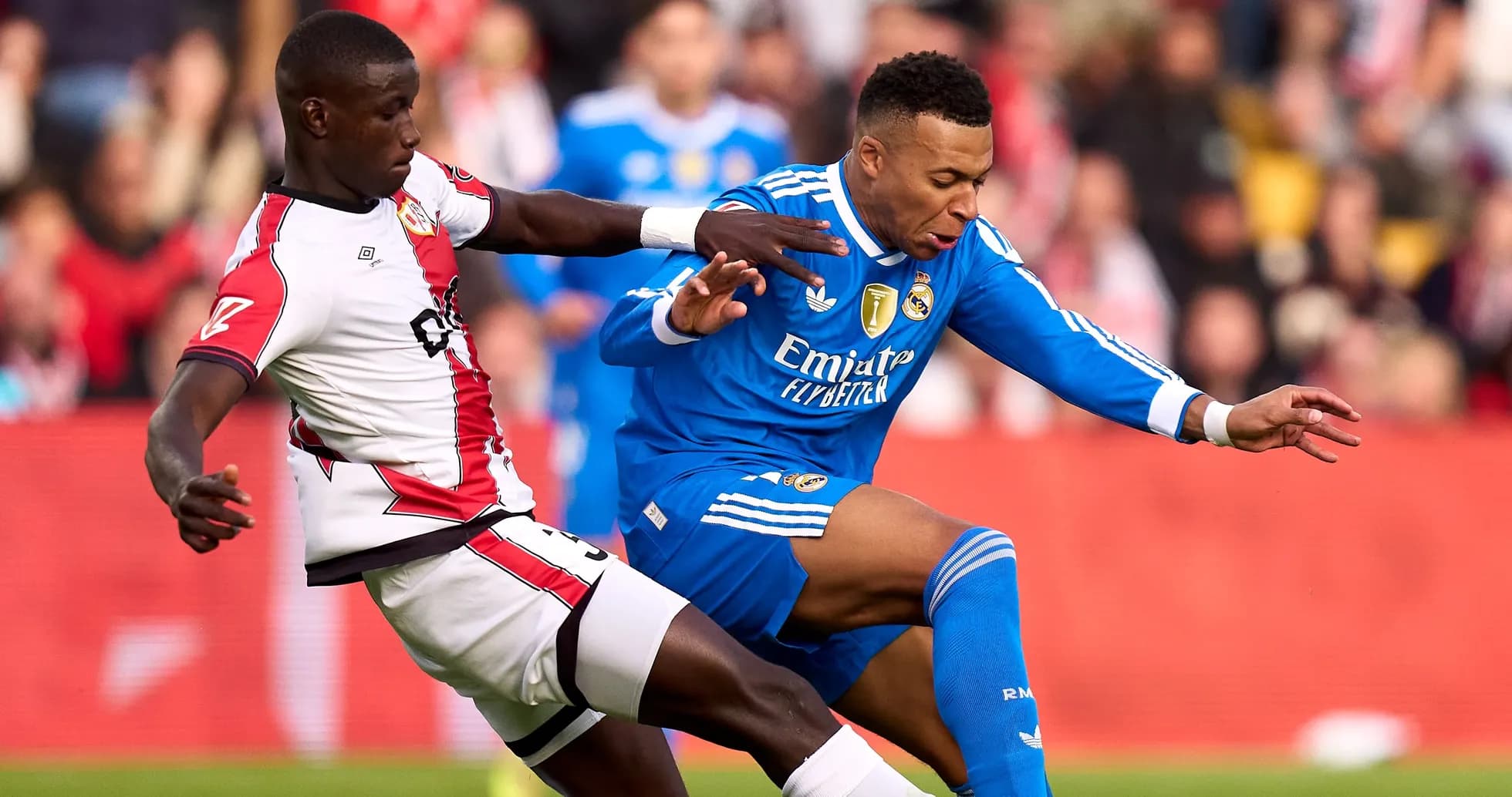Player from Real Madrid being challenged by opponent Player from Real Madrid being challenged by opponent