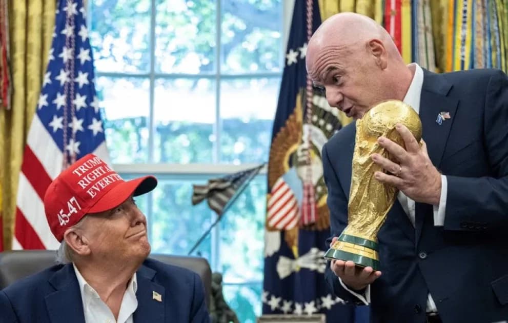 Man holding World Cup trophy with another man watching Man holding World Cup trophy with another man watching