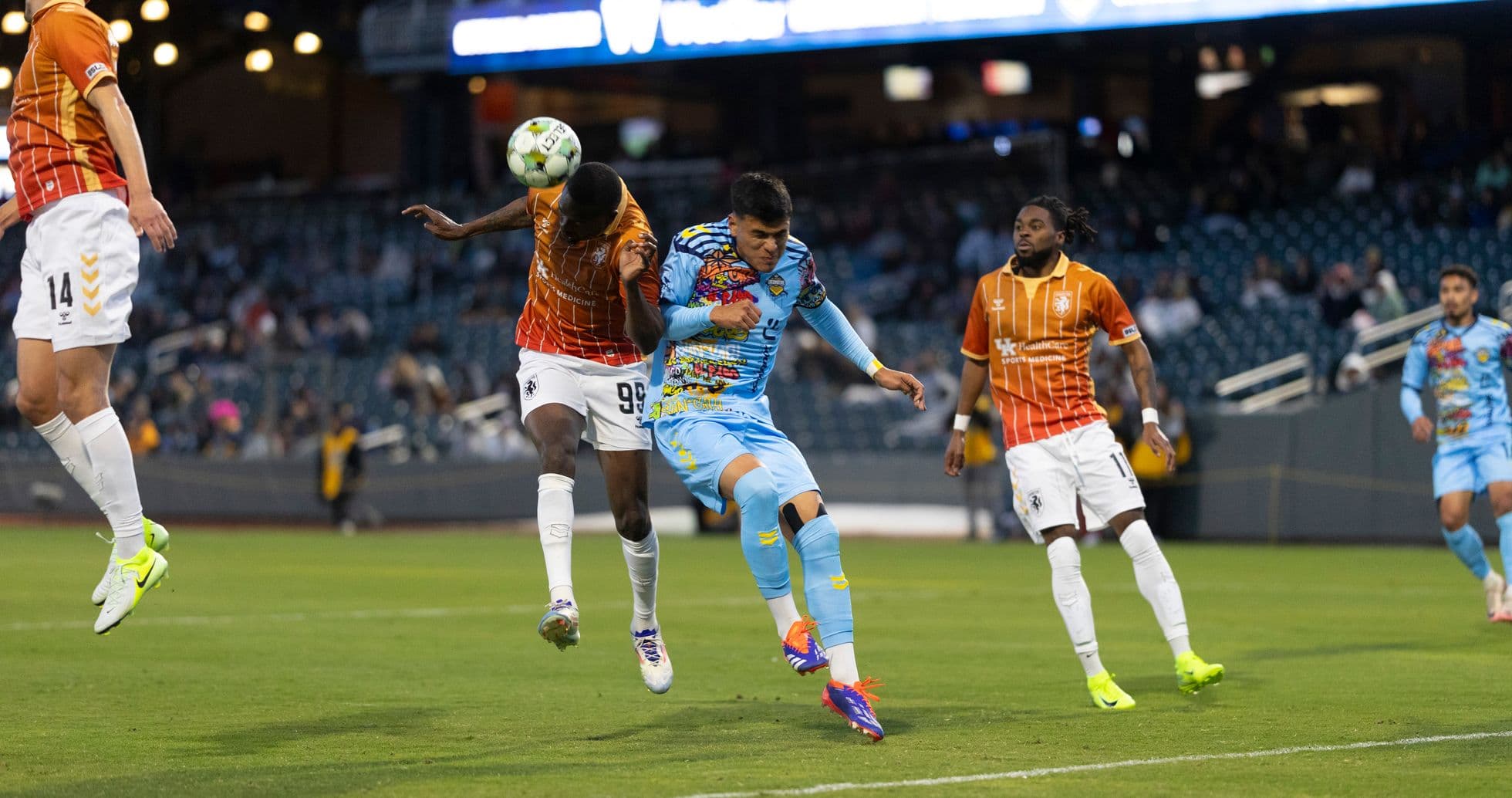 Players contesting for the ball in USL match Players contesting for the ball in USL match