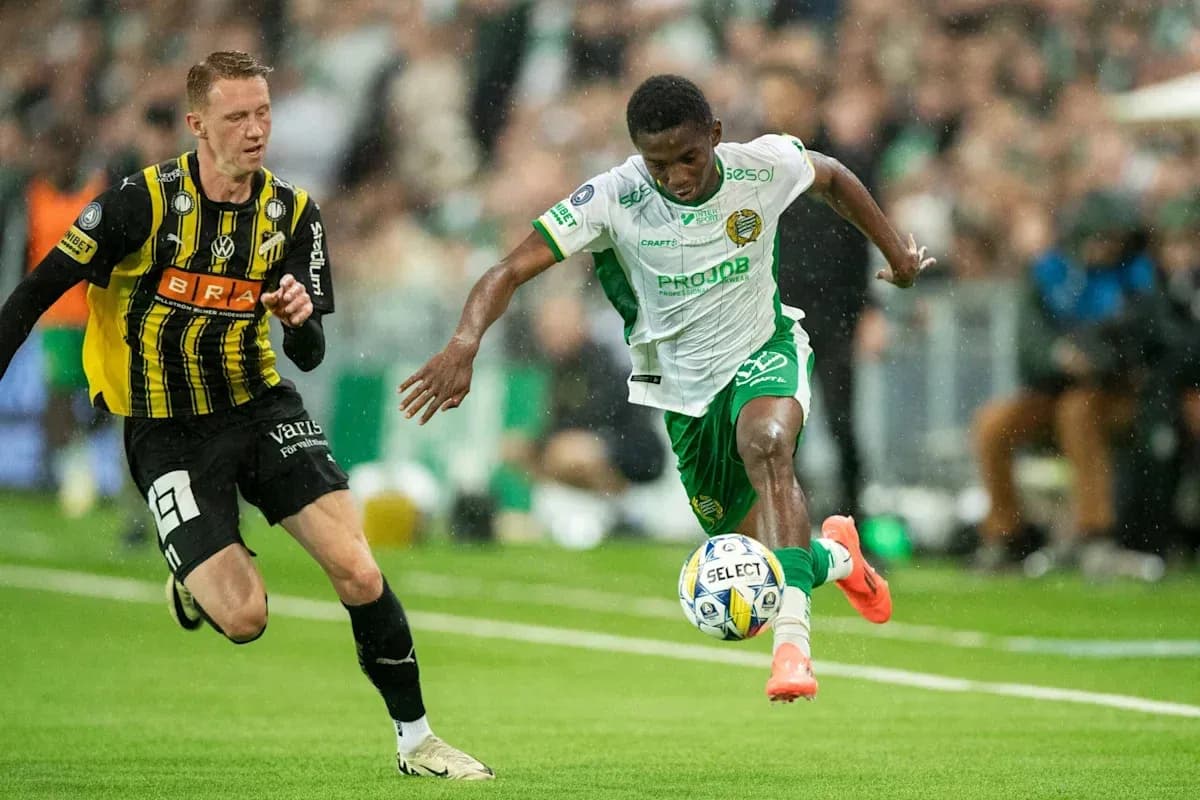 Player dribbling the ball during a football match Player dribbling the ball during a football match