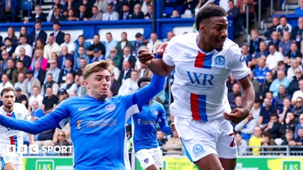 Player in blue shirt attempting to tackle opponent Player in blue shirt attempting to tackle opponent