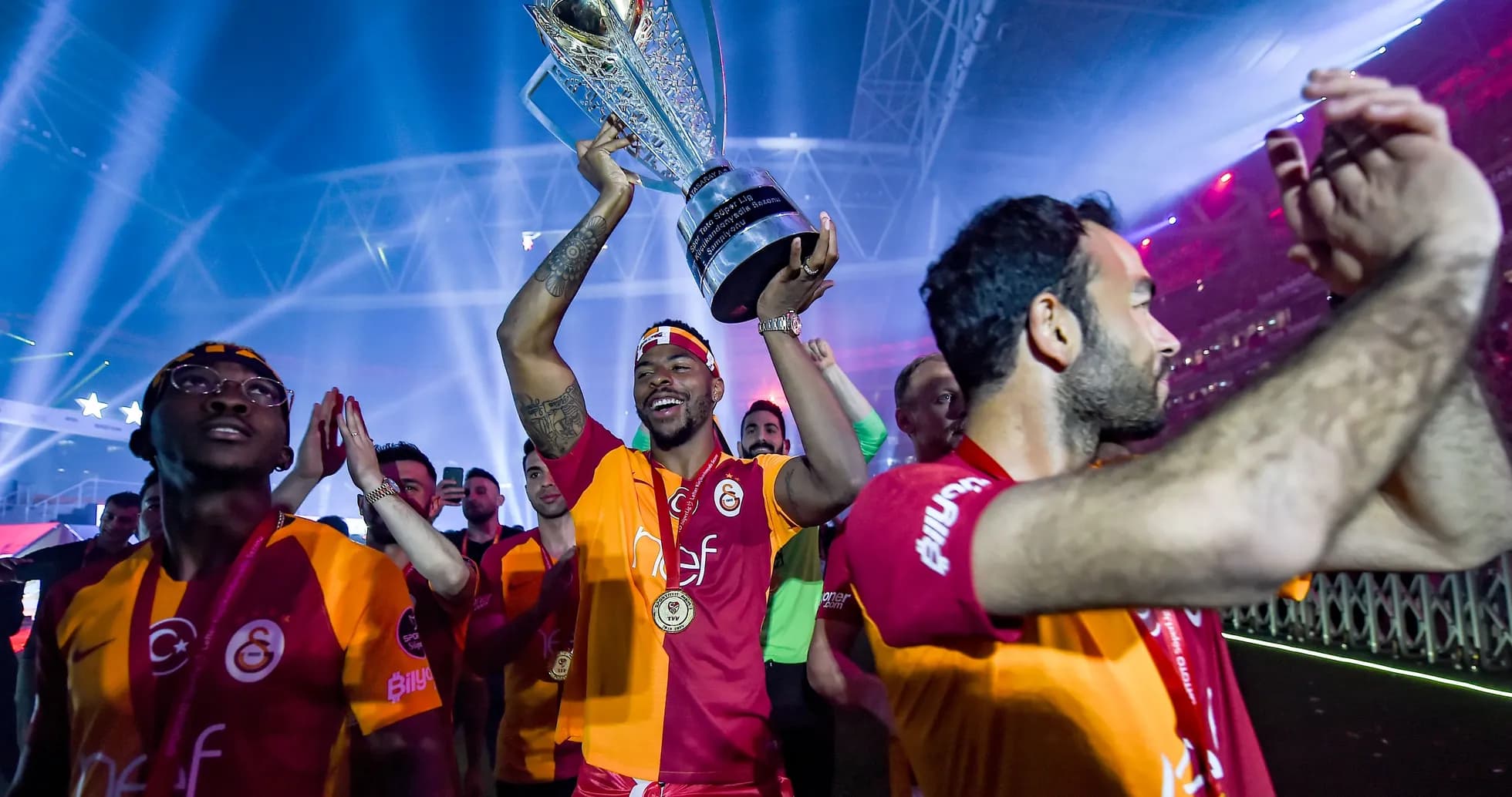 Player celebrating with trophy during victory parade Player celebrating with trophy during victory parade