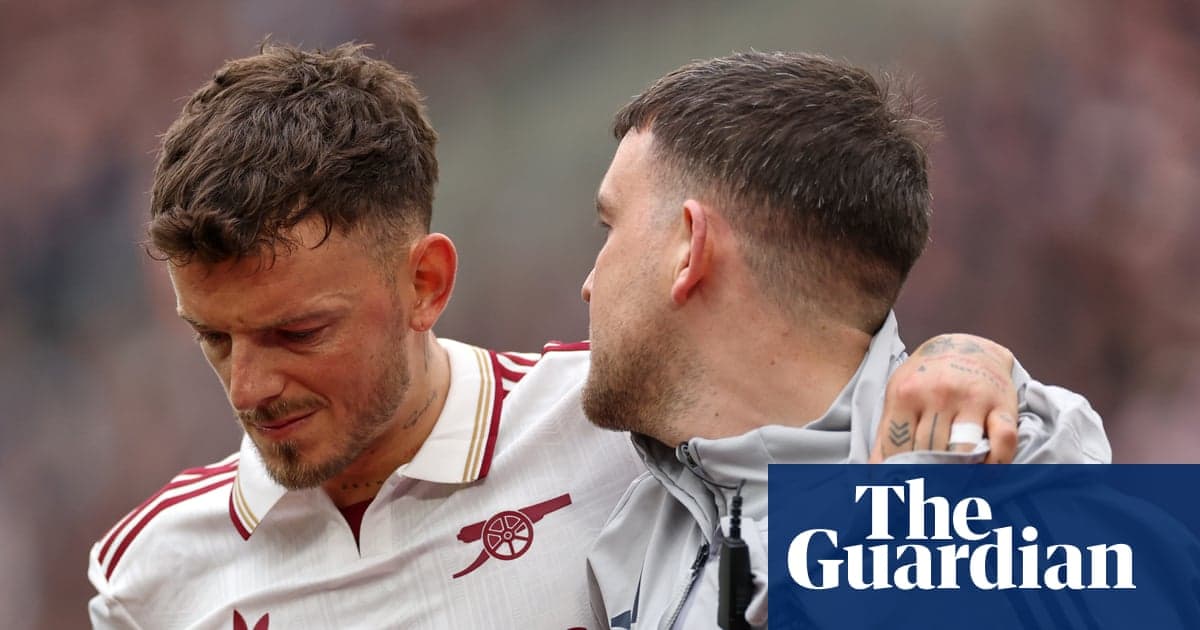 Two players, one comforting the other on field Two players, one comforting the other on field