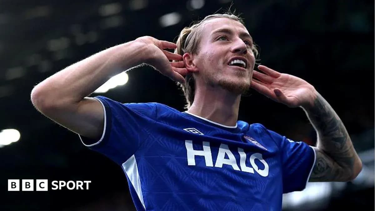 Player celebrating a goal with hands to ears Player celebrating a goal with hands to ears