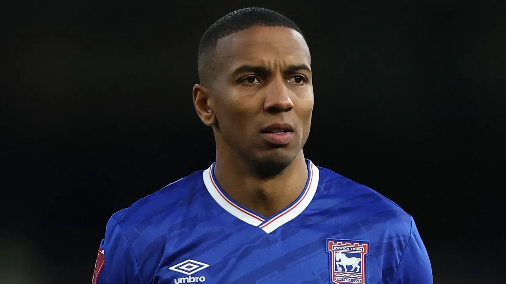 Football player in Ipswich Town jersey on field Football player in Ipswich Town jersey on field