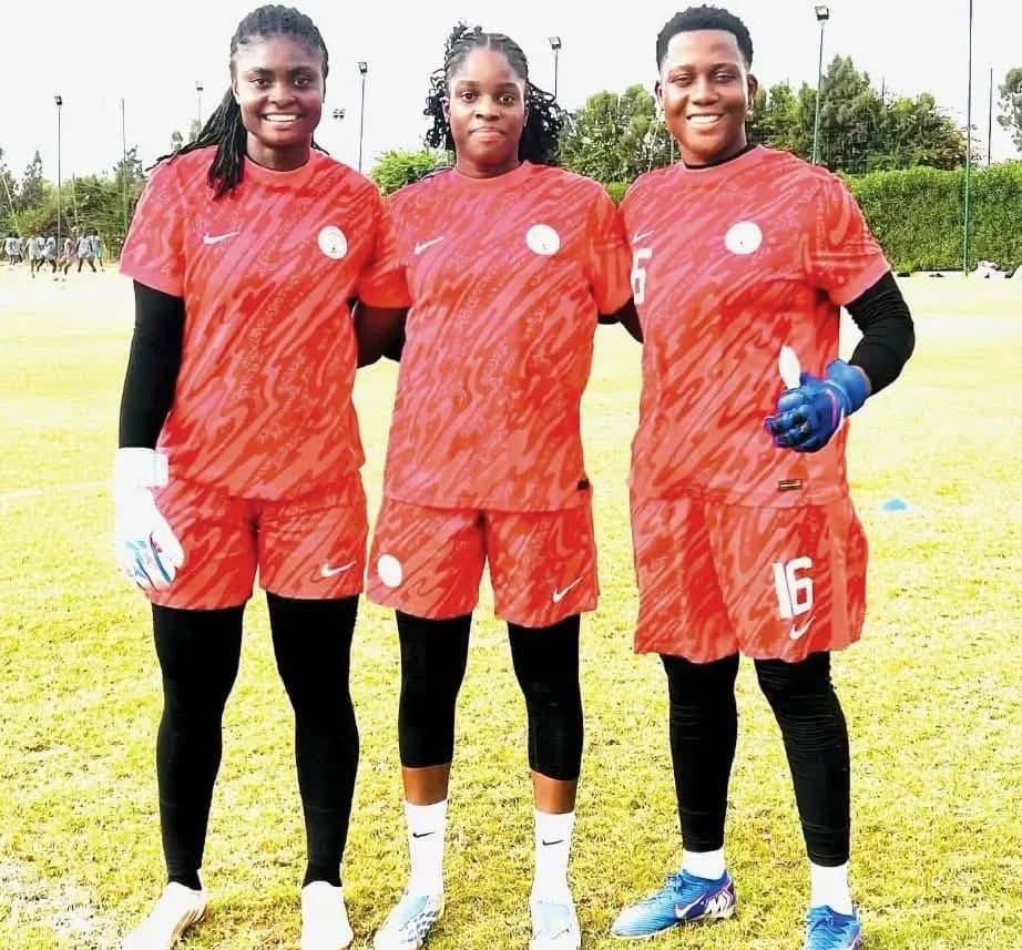 Three female football players posing in training kit Three female football players posing in training kit